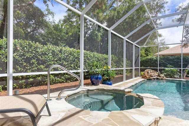 view of swimming pool with an in ground hot tub, a patio, and a lanai