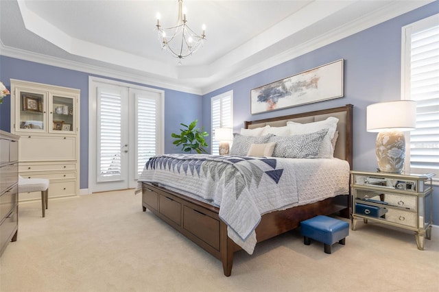 carpeted bedroom with french doors, access to outside, a raised ceiling, crown molding, and an inviting chandelier