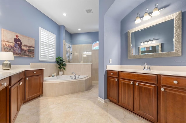 bathroom with vanity and separate shower and tub