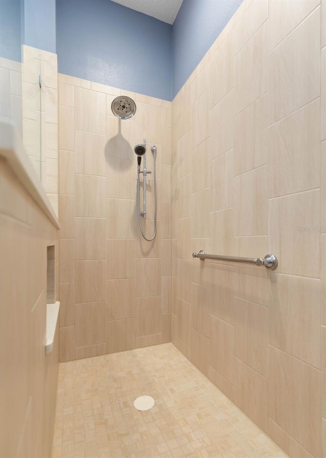 bathroom with a tile shower