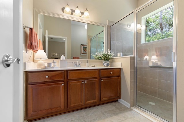 bathroom with tile patterned flooring, vanity, and walk in shower