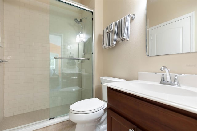 bathroom featuring tile patterned flooring, vanity, toilet, and an enclosed shower