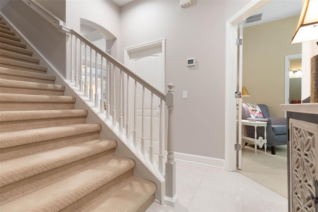 stairs featuring tile patterned flooring