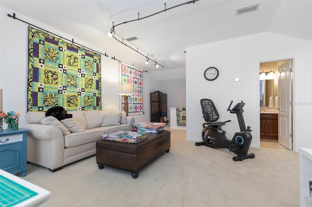 living room featuring light colored carpet and vaulted ceiling