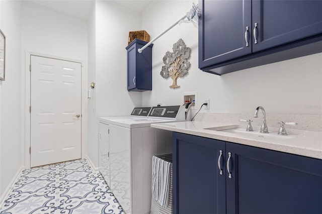 clothes washing area with cabinets, light tile patterned floors, sink, and washing machine and clothes dryer