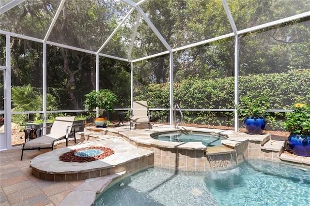 view of swimming pool featuring an in ground hot tub, a patio, and glass enclosure