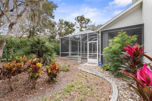 view of yard with glass enclosure