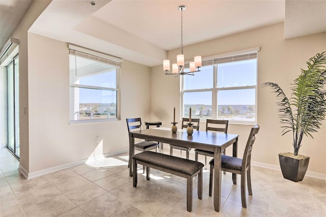 dining room with a mountain view, light tile patterned flooring, and an inviting chandelier