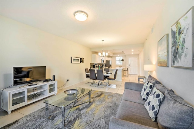 tiled living room featuring a chandelier