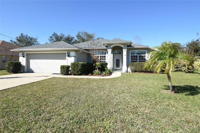 single story home featuring a garage and a front lawn