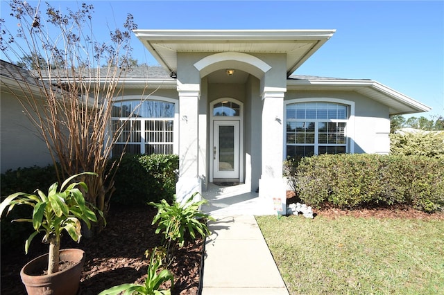 view of exterior entry featuring a yard