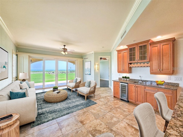 kitchen with ceiling fan, crown molding, sink, wine cooler, and light tile patterned flooring