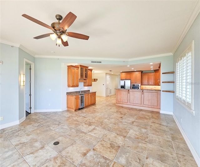 kitchen featuring stainless steel appliances, ceiling fan, crown molding, sink, and wine cooler