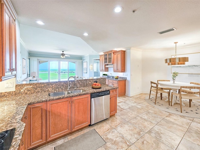 kitchen with ceiling fan, dishwasher, sink, dark stone counters, and pendant lighting