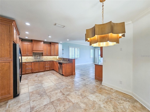 kitchen featuring tasteful backsplash, ornamental molding, pendant lighting, appliances with stainless steel finishes, and custom exhaust hood