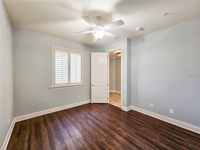 unfurnished bedroom with ceiling fan and dark hardwood / wood-style flooring