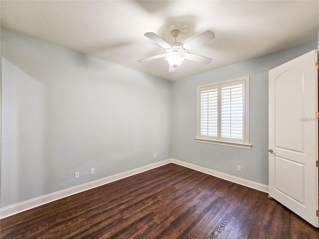 spare room featuring ceiling fan and dark wood-type flooring