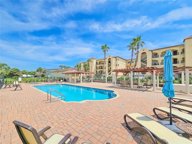 view of swimming pool featuring a pergola and a patio area