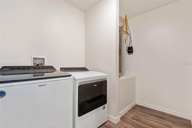 washroom featuring washer and dryer and dark hardwood / wood-style flooring