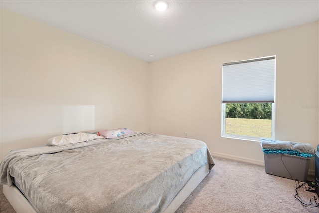 bedroom featuring light carpet