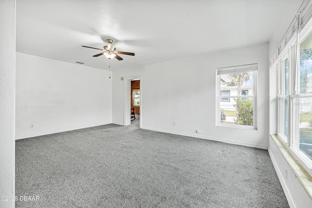 spare room featuring carpet flooring, plenty of natural light, and ceiling fan