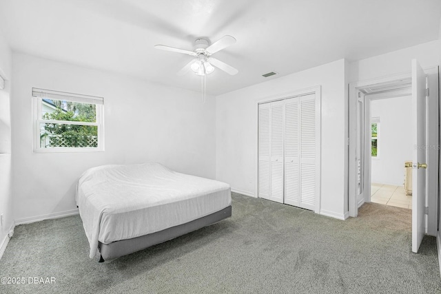 bedroom with ceiling fan, a closet, and carpet floors