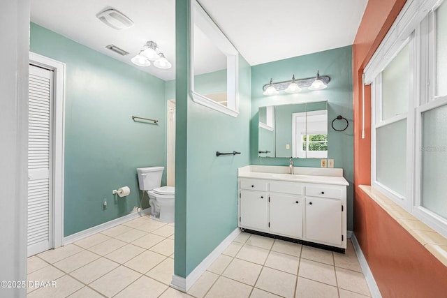 bathroom featuring tile patterned flooring, vanity, and toilet