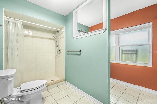 bathroom featuring toilet, tile patterned flooring, and a shower with shower curtain