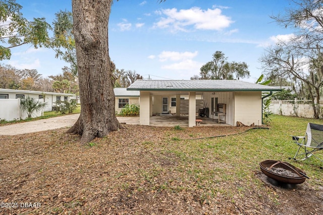 rear view of property with a patio area and a yard