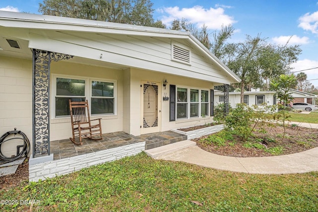 bungalow-style home featuring a porch and a front yard