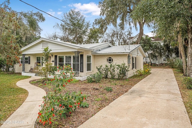 ranch-style home with covered porch and a front yard