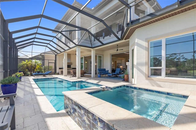 view of swimming pool with a lanai, ceiling fan, a patio area, an outdoor hangout area, and an in ground hot tub