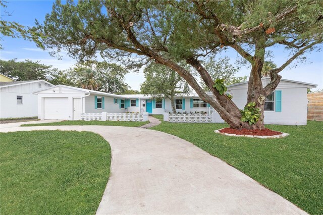 ranch-style house featuring a garage and a front yard