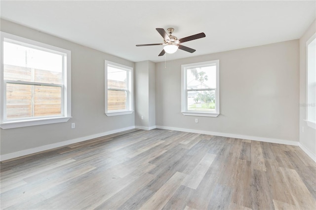 unfurnished room with ceiling fan and light wood-type flooring