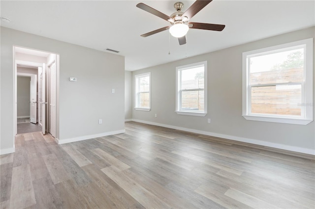 unfurnished room featuring ceiling fan and light wood-type flooring