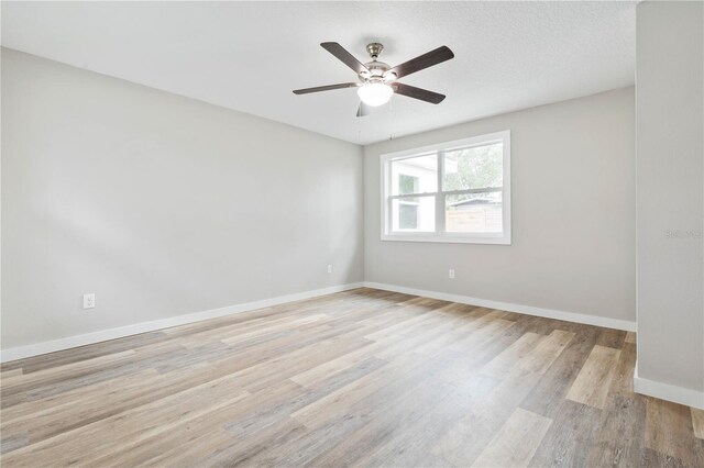 unfurnished room with ceiling fan and light wood-type flooring