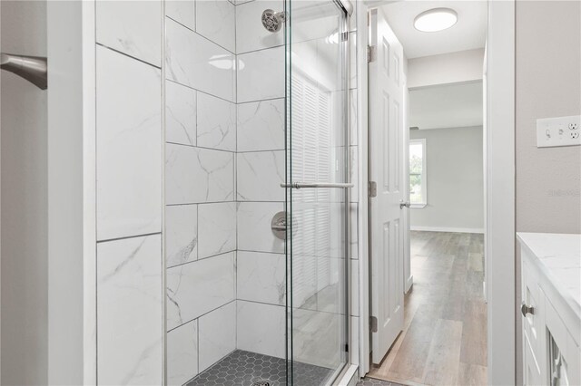 bathroom featuring vanity, hardwood / wood-style flooring, and an enclosed shower