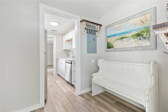 hallway featuring light hardwood / wood-style floors and sink