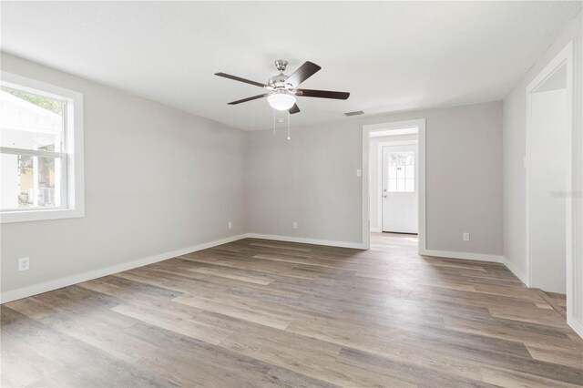 spare room featuring hardwood / wood-style floors and ceiling fan