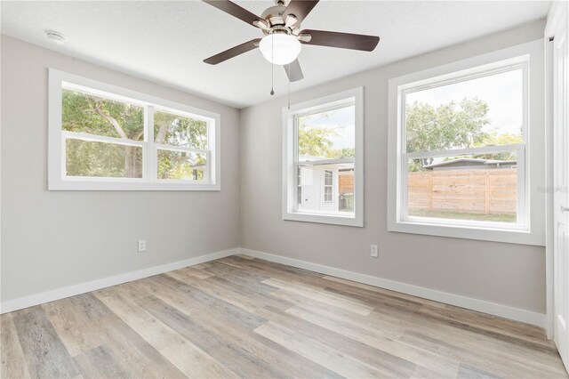 unfurnished room with ceiling fan and light hardwood / wood-style floors