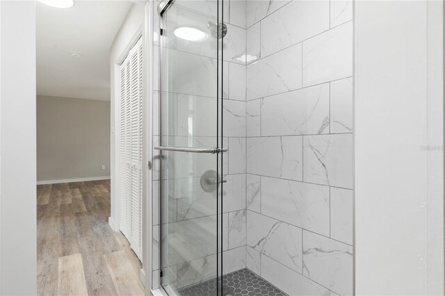 bathroom featuring hardwood / wood-style floors and an enclosed shower