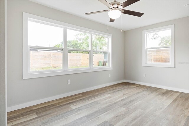 spare room with ceiling fan and light hardwood / wood-style flooring