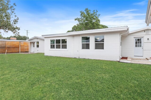 rear view of house with a yard