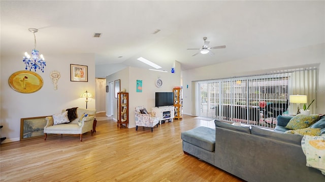 living room with vaulted ceiling, light hardwood / wood-style floors, and ceiling fan with notable chandelier