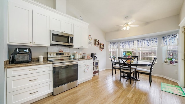 kitchen featuring white cabinetry, ceiling fan, light hardwood / wood-style flooring, backsplash, and appliances with stainless steel finishes