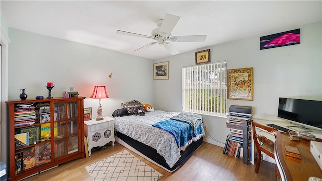 bedroom with ceiling fan and light wood-type flooring