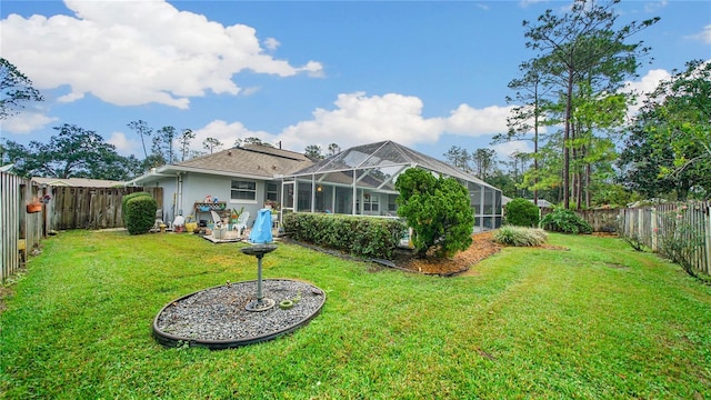 rear view of house with a lanai and a yard