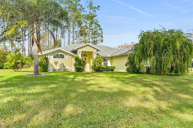 single story home featuring a front lawn