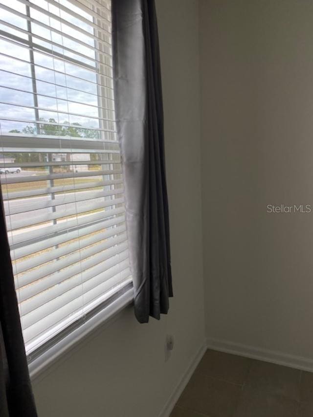 empty room featuring dark tile patterned floors