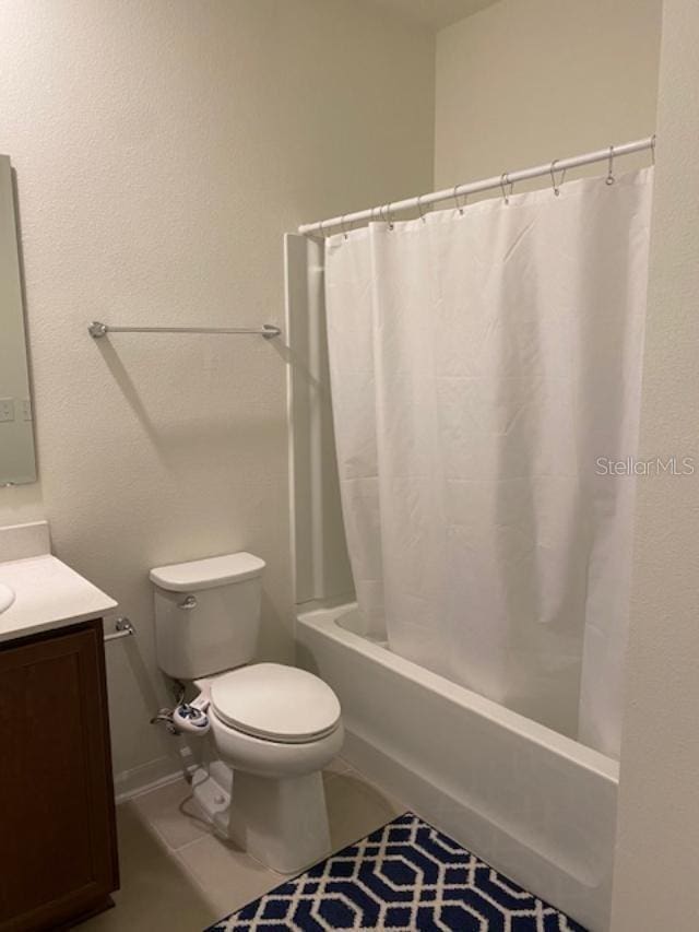 full bathroom with shower / bath combo, toilet, tile patterned flooring, and vanity